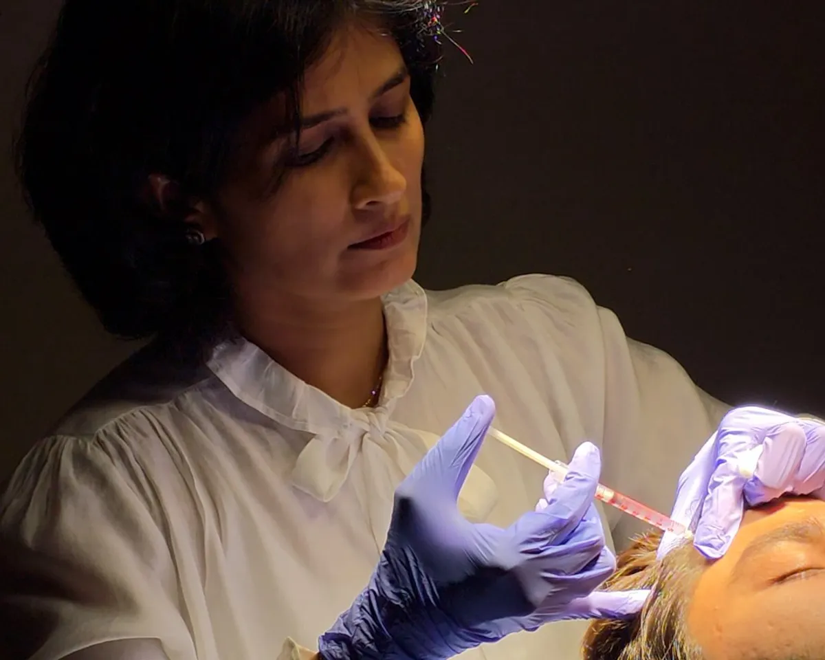 Dr. Daksha Patel performing an injectable treatment on a patient