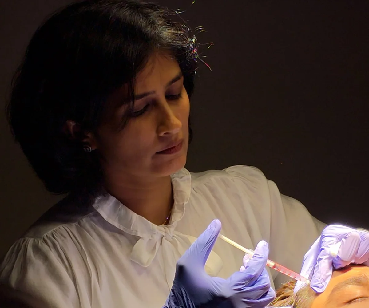 Dr. Daksha Patel performing an injectable treatment at Skin Essence