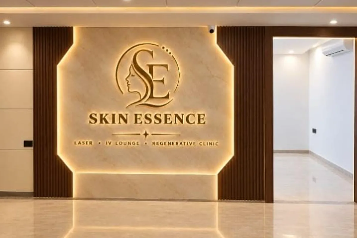 Reception of the Skin Essence clinic in Kalyani Nagar, Pune, with the backlit Skin Essence logo on a marble wall