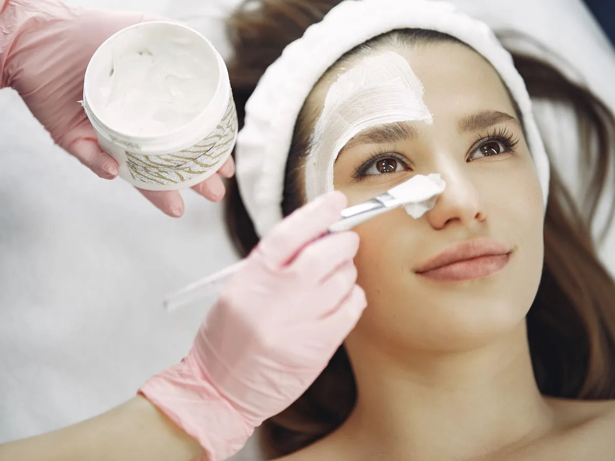 Chemical peel solution being brushed onto a patient's face