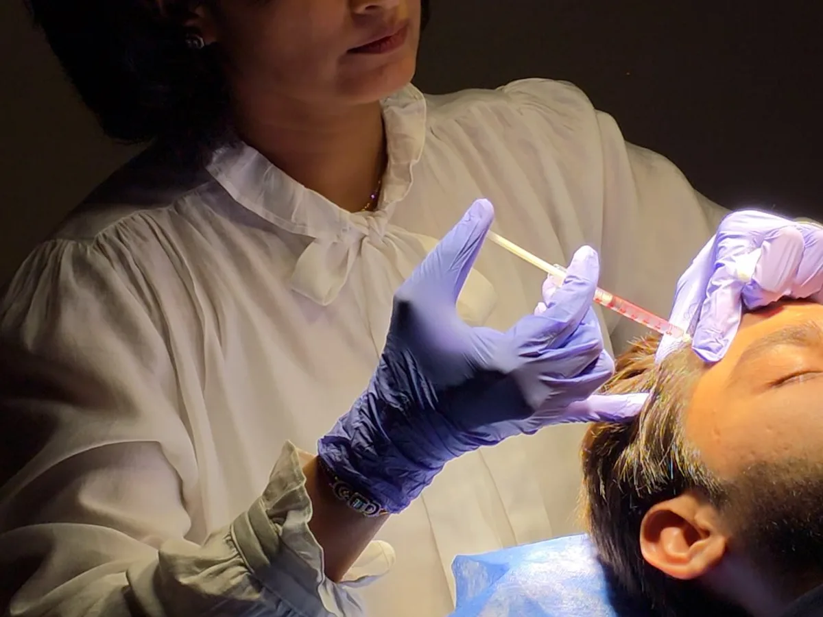 Dr. Daksha Patel performing an injectable treatment at Skin Essence