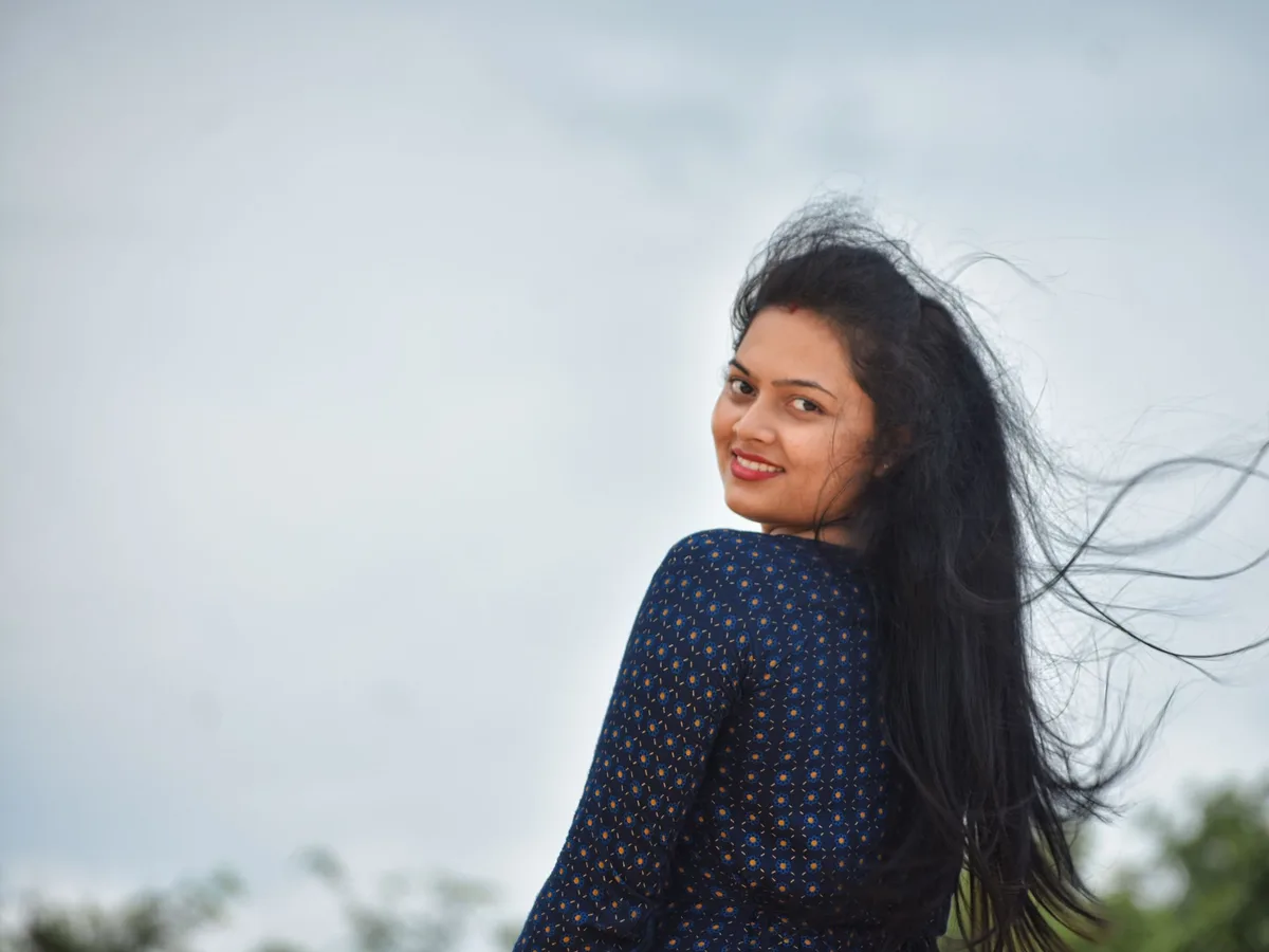 Woman with long, healthy hair smiling outdoors
