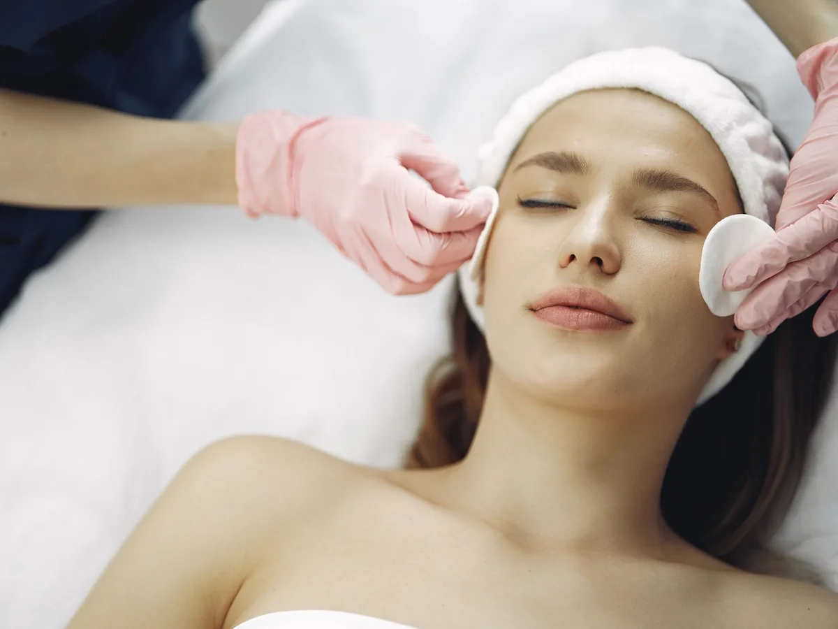 Woman relaxing during a gentle facial peel treatment at a skin clinic