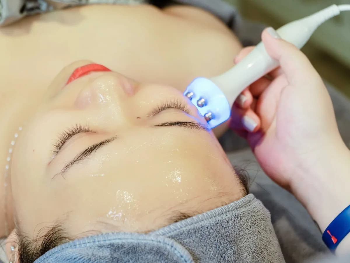 Ultrasound skin tightening handpiece being used on a patient's face
